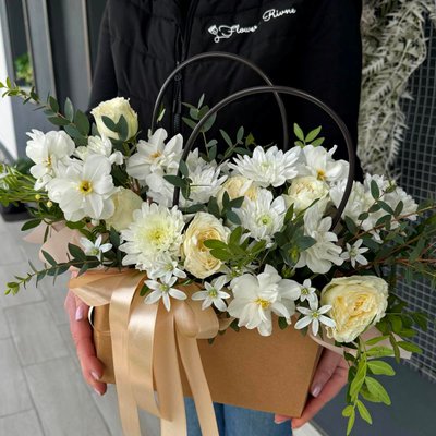 Mix of bright flowers in a floral bag